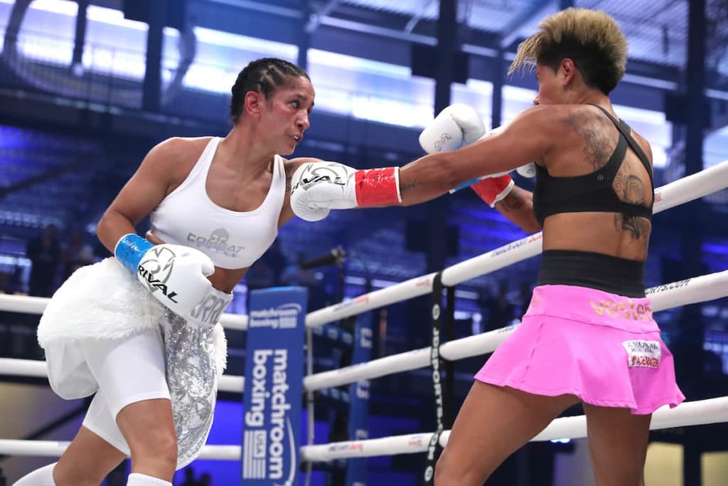 Amanda Serrano (left) would have the same knockout percentage as George Foremann if George fought two minute rounds his entire career. Photo Ed Mulholland, Matchroom Boxing USA 