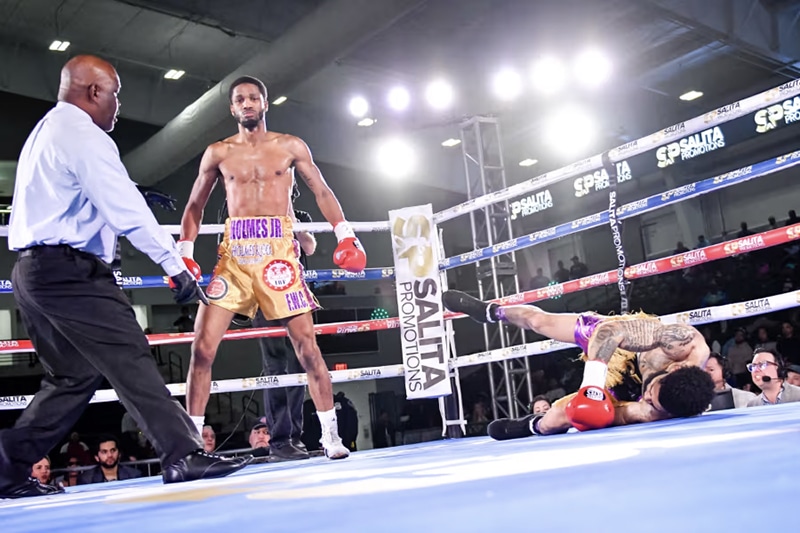 Ardreal Holmes Jr. knocks down Marlon Harrington in his August 30 fight. Photo: Adam J. Dewey, Salita Promotions Big Time Boxing USA