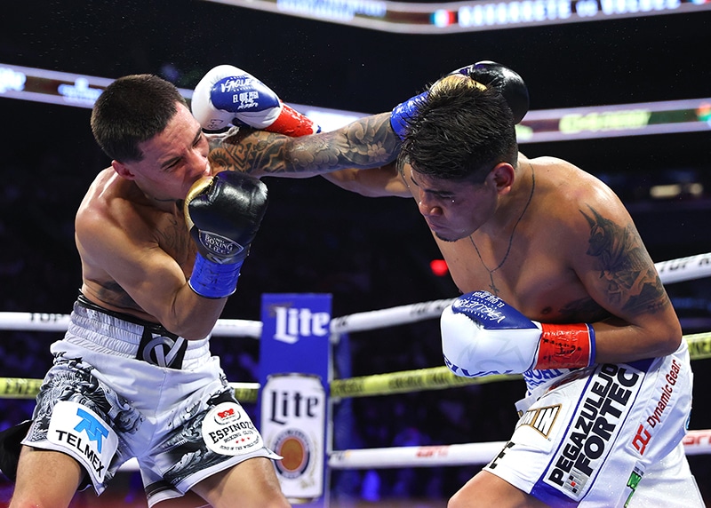 Emanuel Navarrete and Oscar Valdez didn't hold back for a second of their six round fight. Photo: Mikey Williams, Top Rank