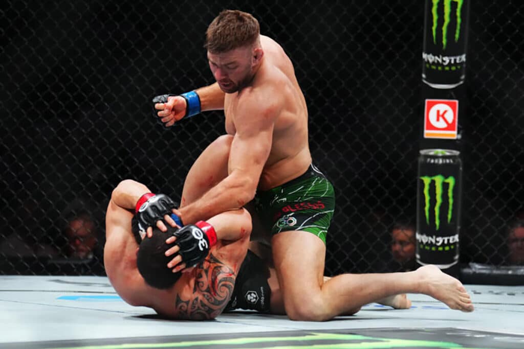 Dricus Du Plessis of South Africa punches Robert Whittaker of New Zealand in a middleweight fight during the UFC 290 event at T-Mobile Arena on July 08, 2023 in Las Vegas, Nevada. Photo: Chris Unger/Zuffa LLC via Getty Images