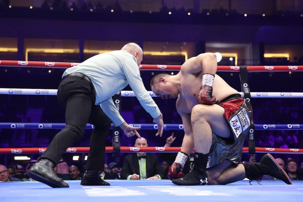 Zhilei Zhang could not beat the count after taking a knee to survive a body shot from Agit Kabayel. Photo: Mark Robinson, Matchroom Boxing