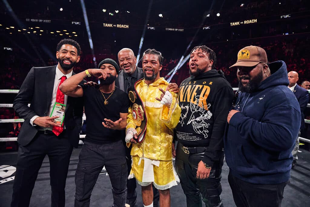 Gary Antuanne Russell with his brother and trainer Gary Russell Jr. and the rest of his team celebrate his victory. Photo: Esther Lin, Premier Boxing Champions