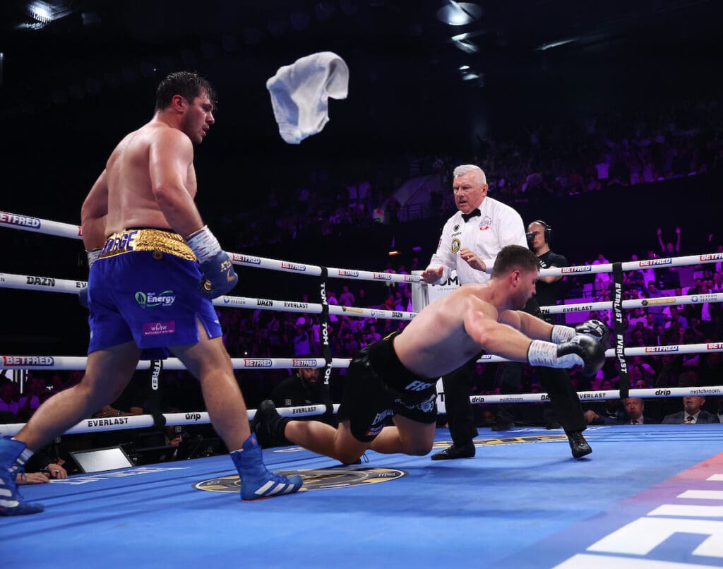 Johnny Fisher falls to the canvas at the end of round five as his corner throws in the towel, giving a fifth round KO win to Dave Allen for the WBA Intercontinental Heavyweight Title.Photo: Mark Robinson. Matchroom Boxing.