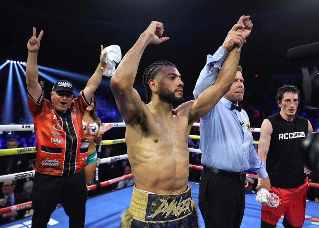 Not even winning the IBF World Interim Lightweight title could make Raymond Muratalla crack a smile, so trainer Robert Garcia did for him. Photo: Mikey Williams, Top Rank Boxing