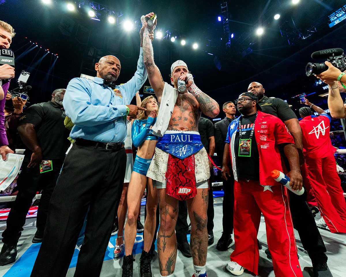 Jake Paul celebrates his win with brother Logan and trainer Theo Chambers. Photo: Esther Lin, Most Valuable Promotions