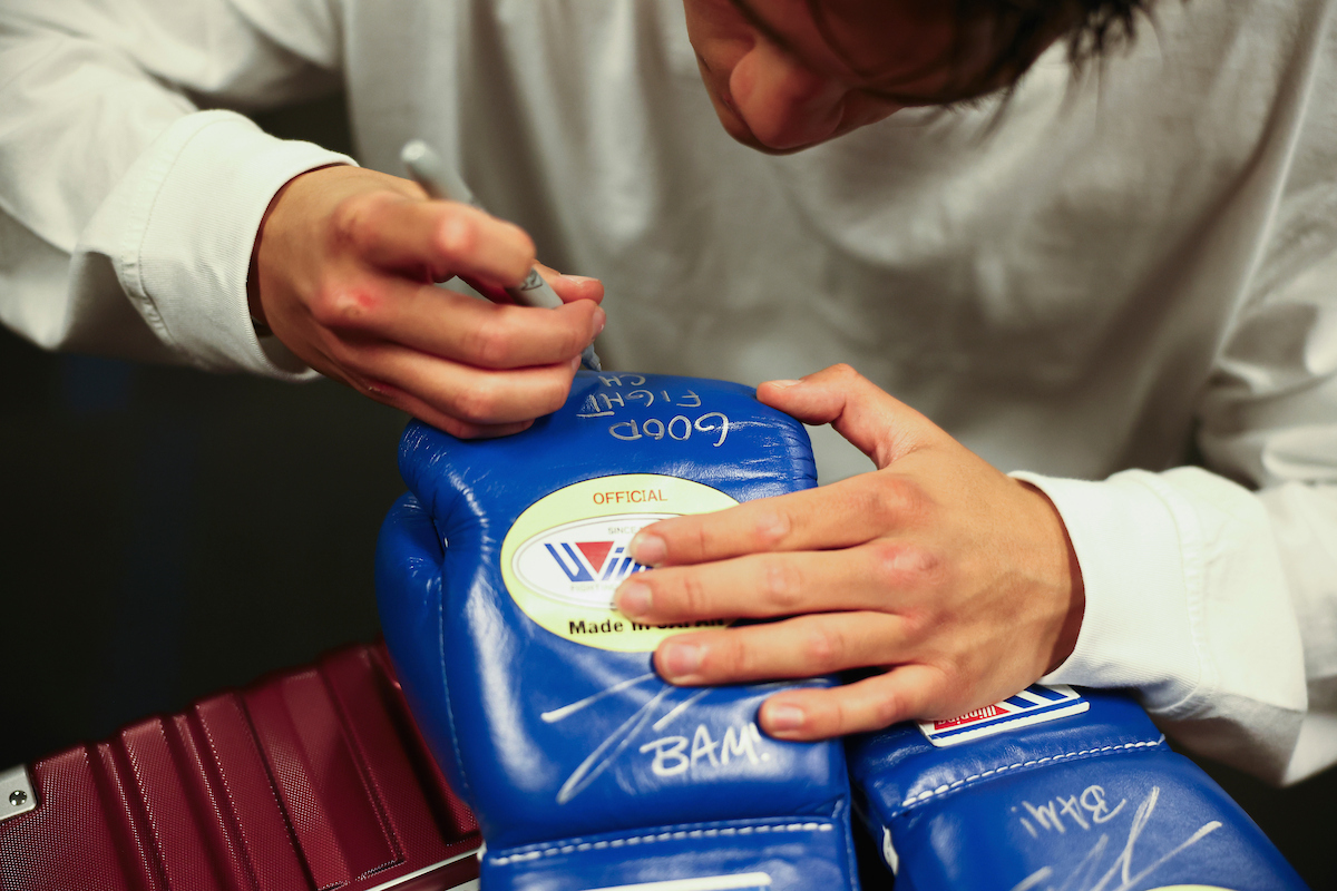 Bam Rodriguez signs gloves for Phumelela Cafu after their WBC, WBO, and Ring Magazine super flyweight fight on Saturday. He wrote, "Good Fight Champ!" Photo: Melina Pizano/ Matchroom