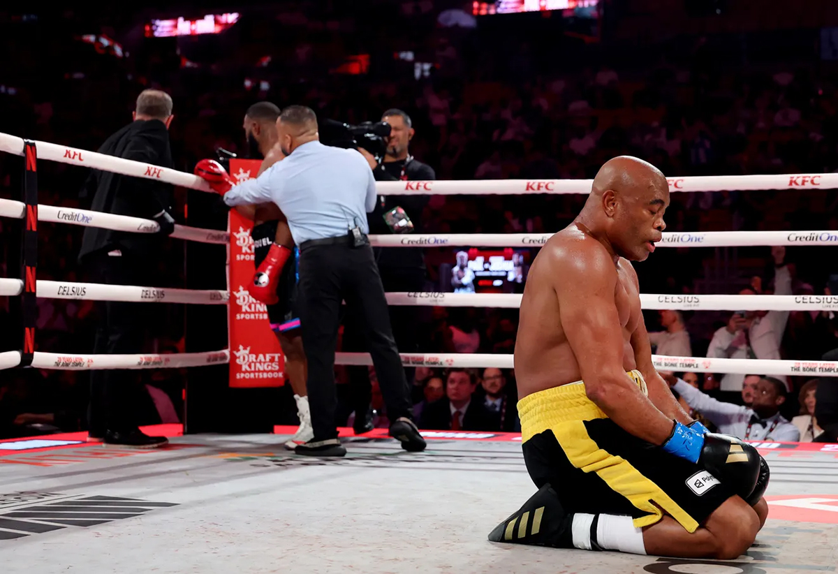 Anderson Silva drops to his knees, celebrating his knockout victory over Tyron Woodley Saturday on the Jake vs Joshua undercard. Photo: Ed Mulhollland/Getty Images for Netflix