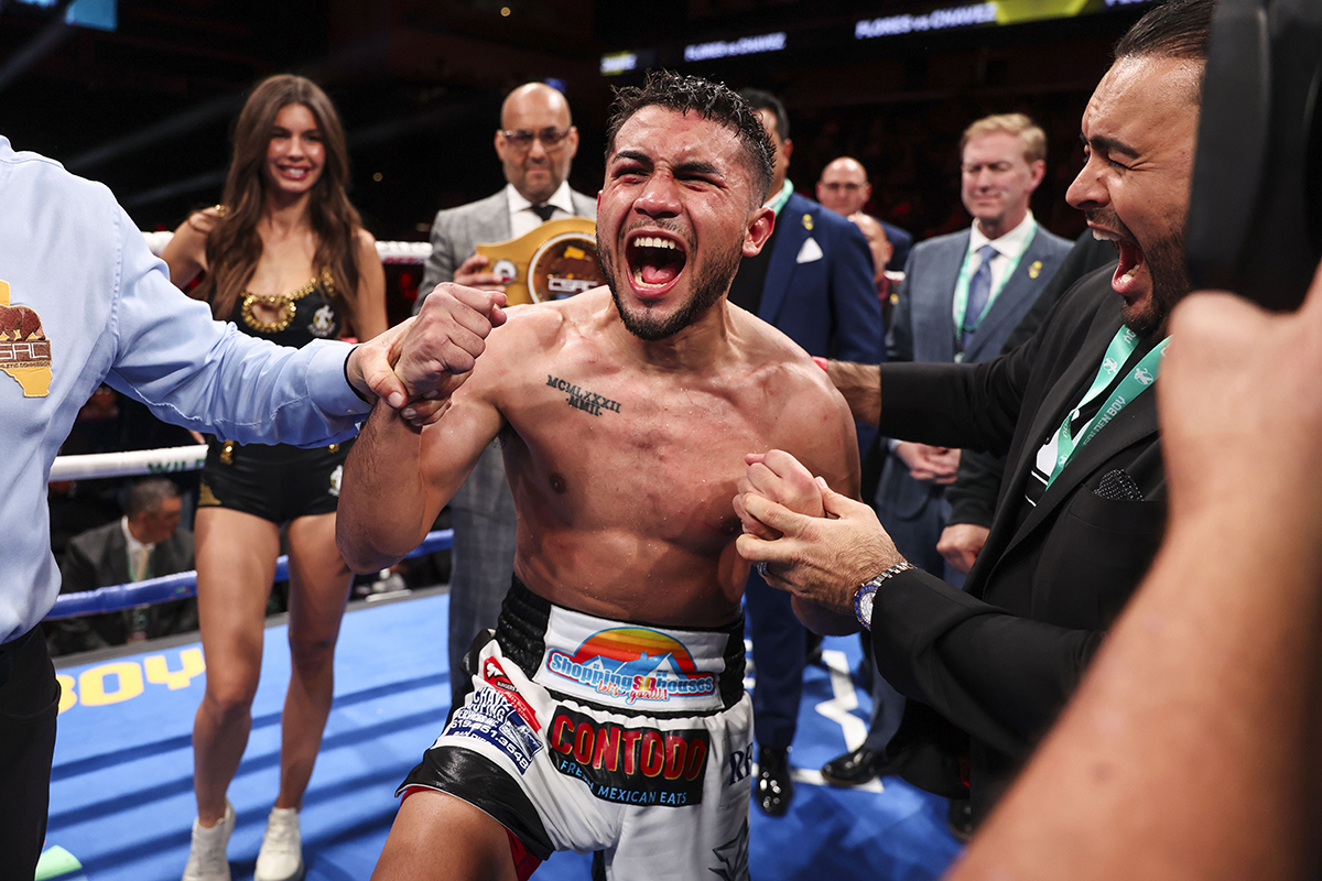 Jorge Chavez celebrates his victory over Manny Flores, with manager Frank Espinoza (right). Photo: Cris Esqueda, Golden Boy Boxing