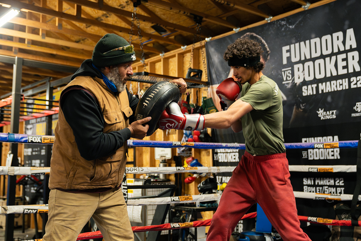 Trainer and father Freddy Fundora puts his son, world super welterweight champion Sebastian Fundora, through training with the class Mexican round shield. Photo: Ryan Hafey, Premiere Boxing Champions