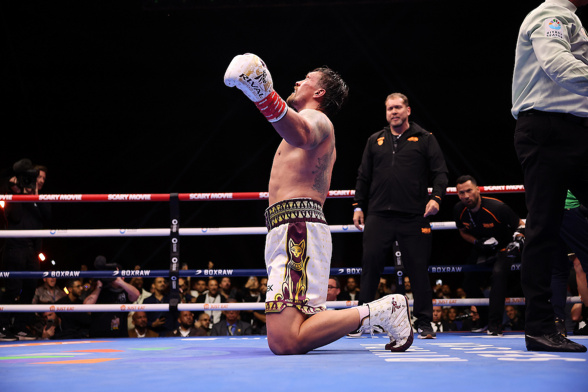 Oleksandr Usyk falls to his knees after stopping Rico Verhoeven to defend his WBC World Heavyweight title on Saturday in Giza, Egypt. Photo: Mark Robinson, Matchroom Boxing