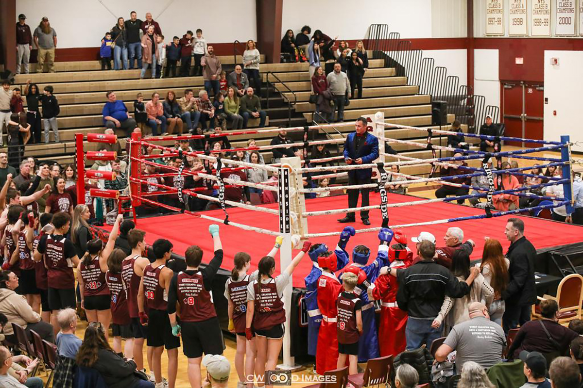 Members of the 94th mission bouts group shot around the ring with Mike Davis ’95 as MC for the night Photo: Aquinas Institute