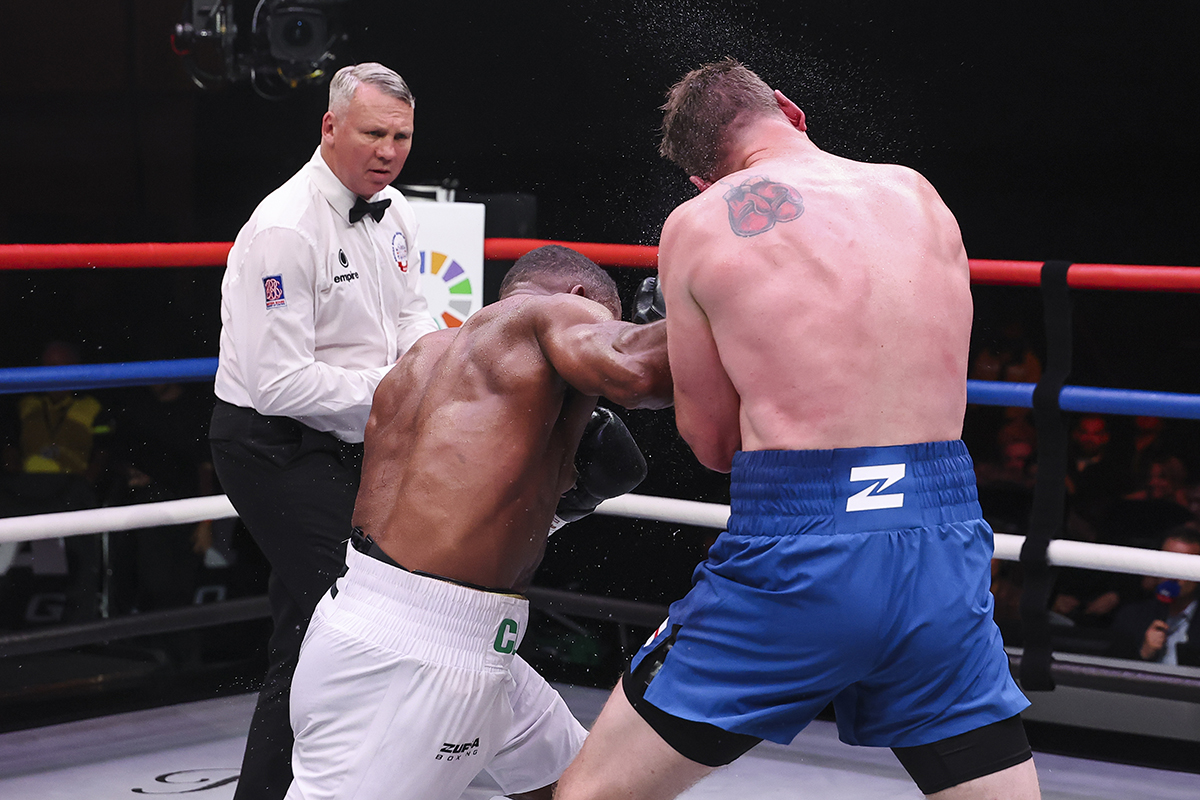 Chev Clarke unloads an unexpected money punch against Jack Massey. Photo: Ed Mulholland, Zuffa Boxing 07