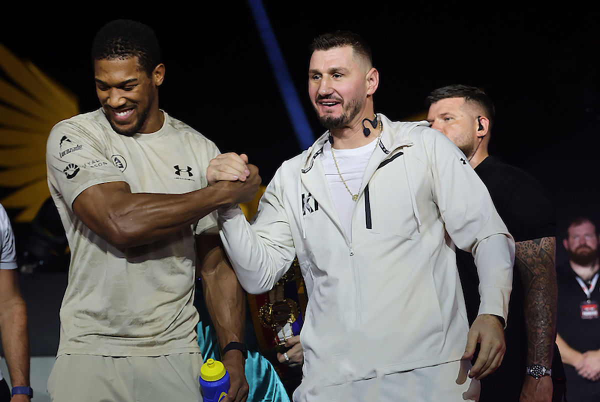 Anthony Joshua and Kristian Prenga are all smiles after their faceoff on Thursday in Jeddah, Saudi Arabia. Photo: Mark Robinson, Matchroom Boxing.