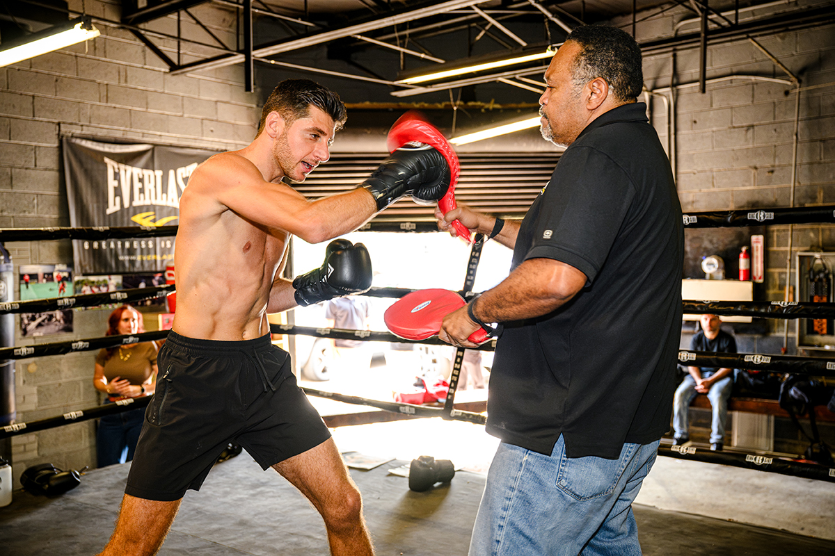 Jonny Mansour puts in work during last week's media event at Tony Harrison's Superbad Gym with trainer Berlin Kearny. Photo: Andrew Potter, Salita Promotions