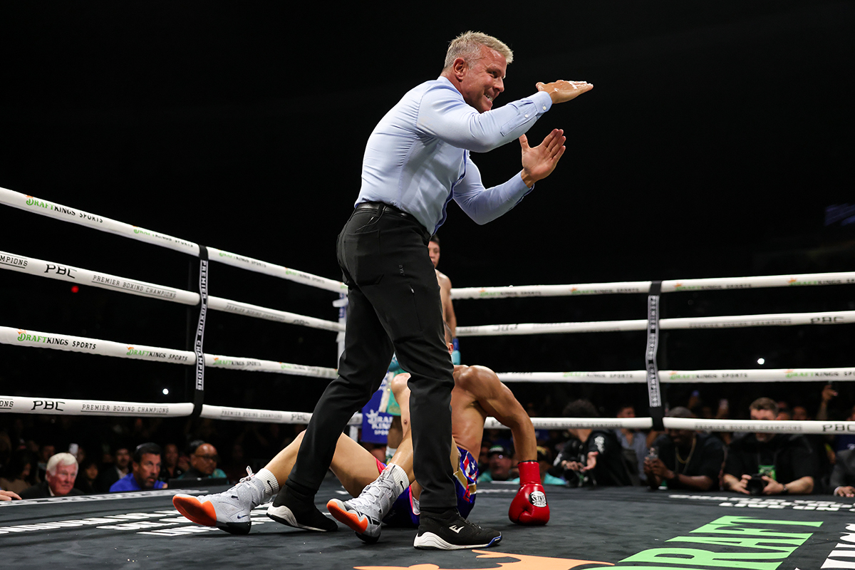 Veteran referee Thomas Taylor earned his paycheck the hard way trying to keep order between Nestor Bravo and Pitbull Cruz. Photo: Cris Esqueda, Premier Boxing Champions