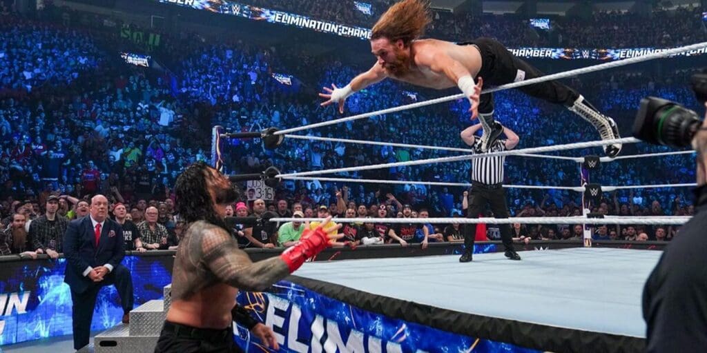 Sami Zayn diving at Roman Reigns