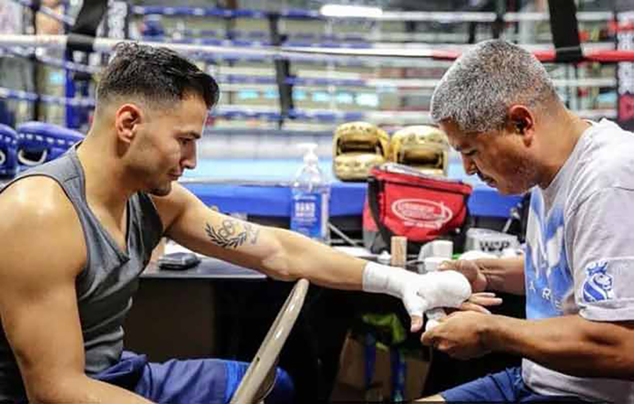 Robert Garcia wraps the hands of Lindolfo Delgado for a training session at the Robert Garcia Boxing Academy. Photo: Top Rank Boxing
