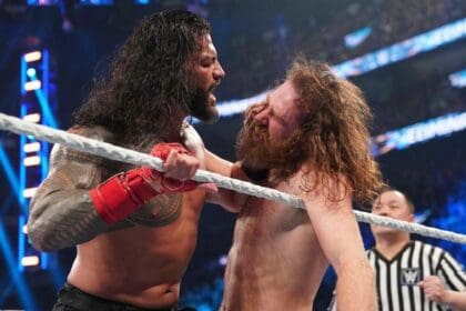 Roman Reigns shoving Sami Zayn's face