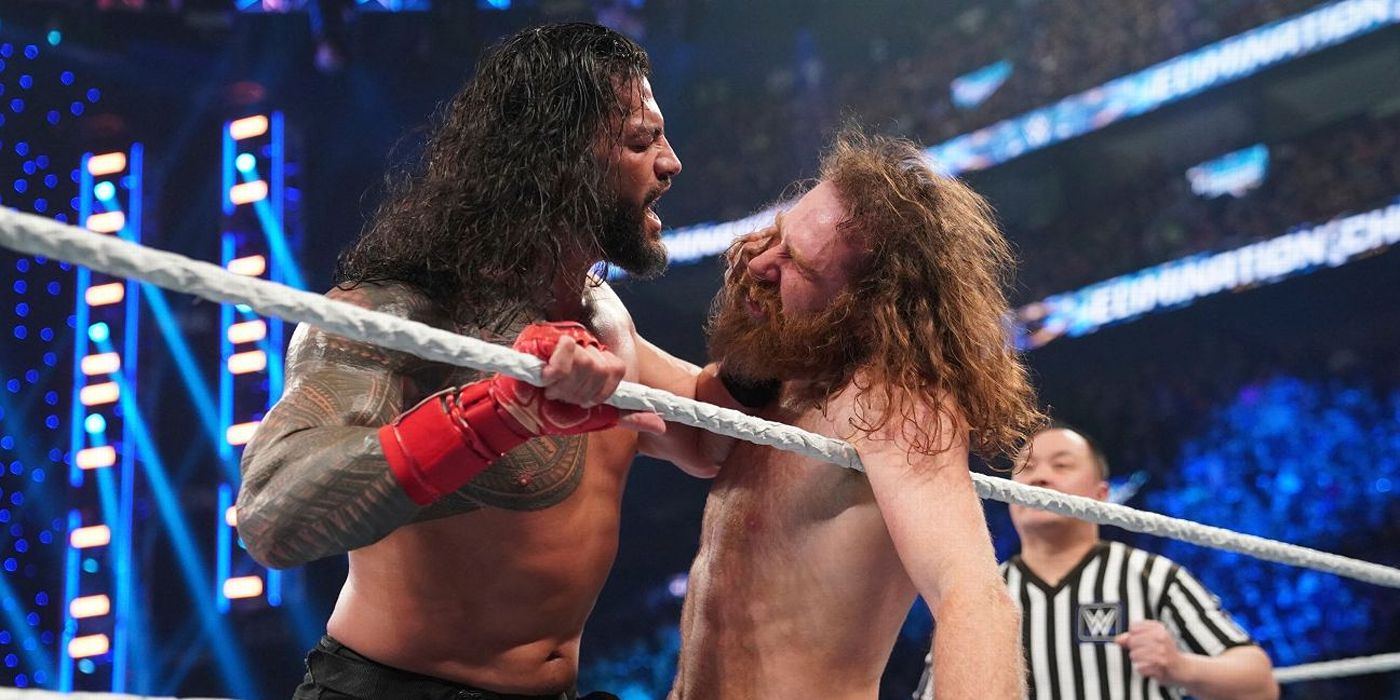 Roman Reigns shoving Sami Zayn's face